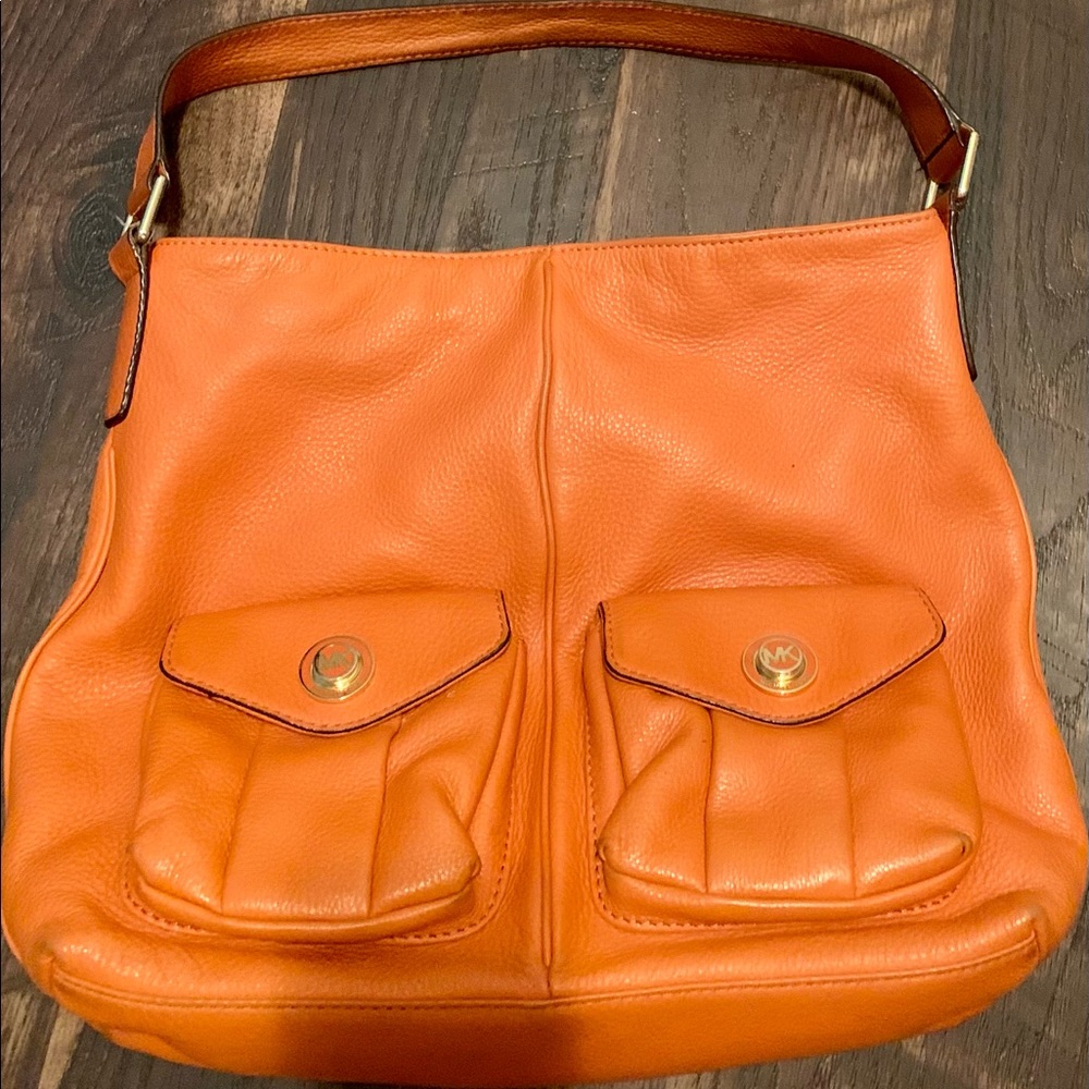 Super cute orange and gold slouch Michael Kors leather purse.